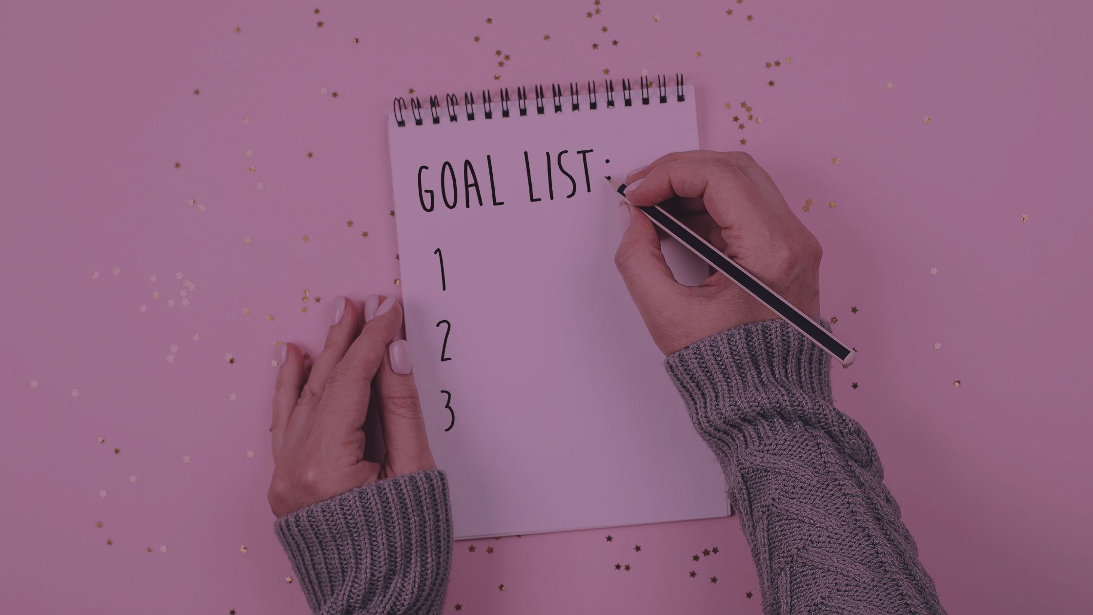 Lisa's Corner - When Goals Work Against You - Header Image Goals or Standards? picture of empty list of goals on a piece of paper with hands, one holding a pencil prepared to write